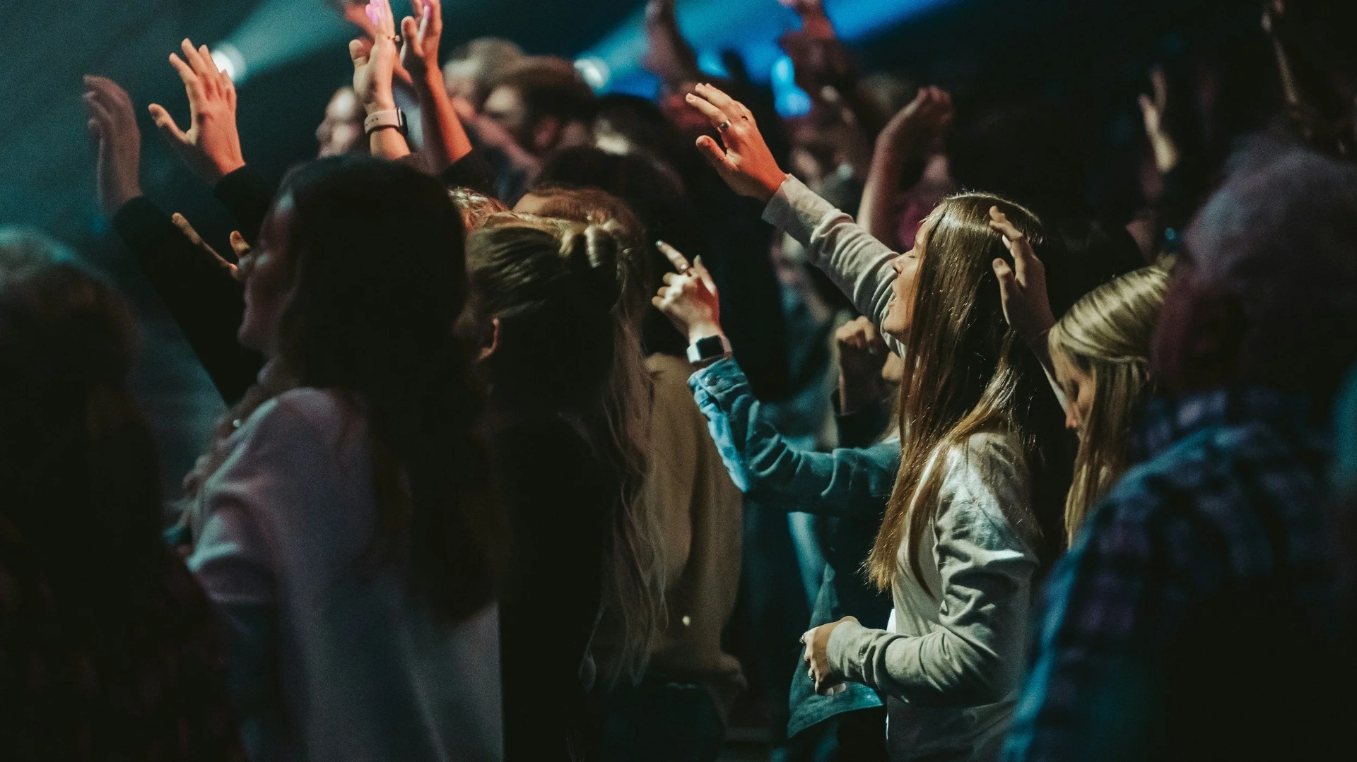 Hands raised in worship at a Red Seal Ministries gathering